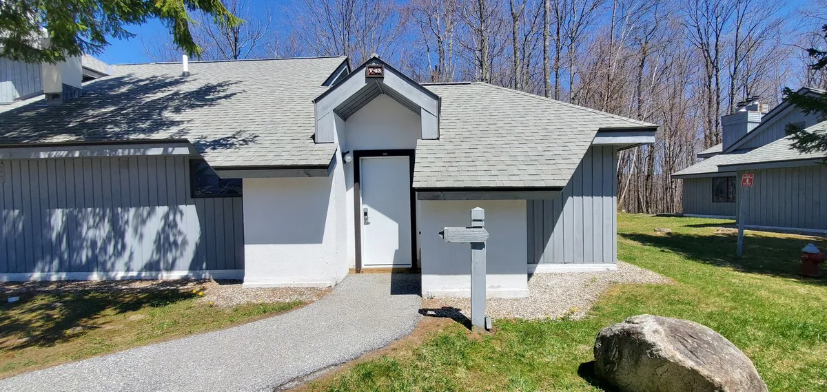 An inviting exterior view of the home's front entrance, featuring a well-kept pathway, attractive landscaping, and a welcoming front door. The surrounding greenery hints at the quiet, residential neighborhood and the ease of coming and going for local exploration.